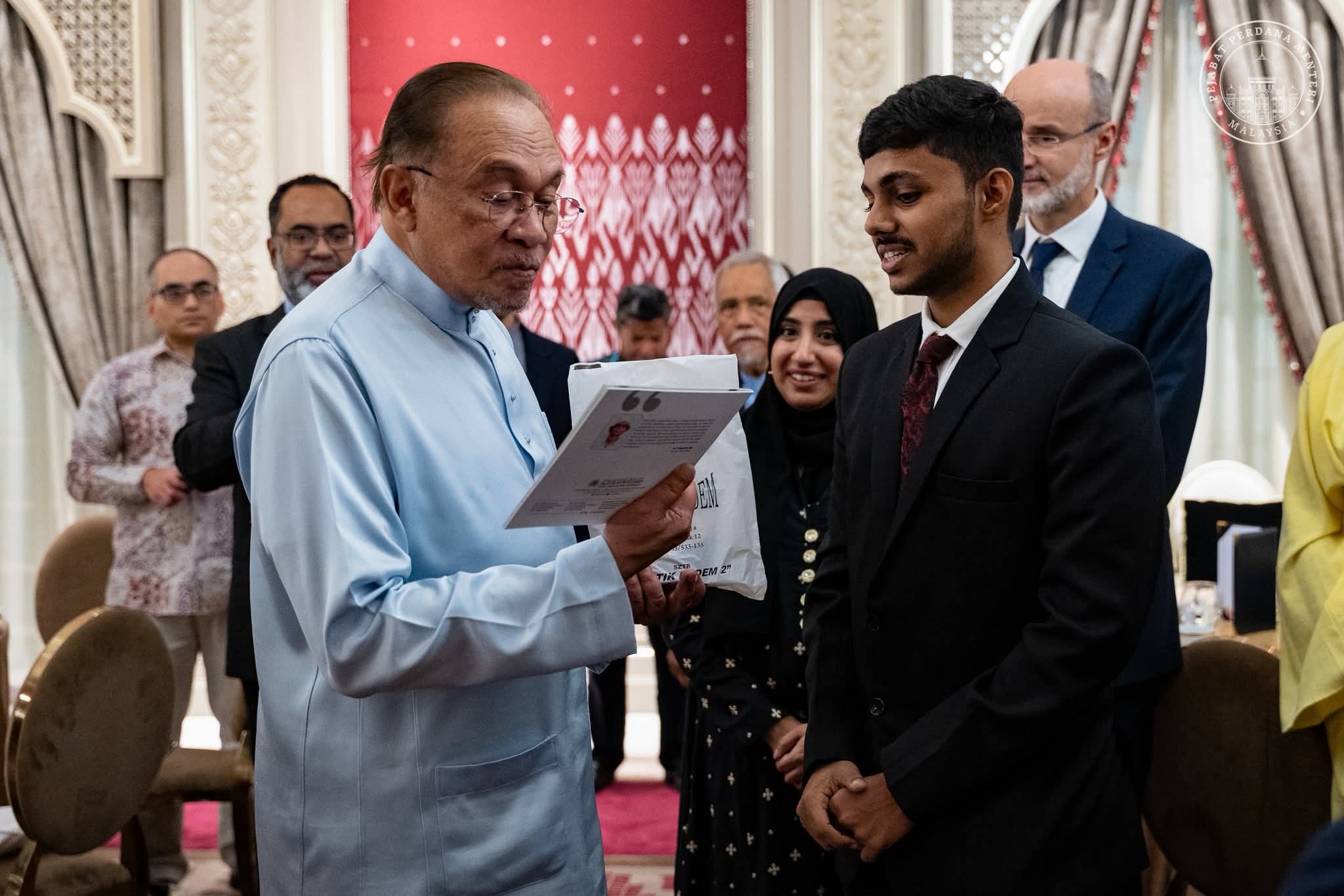 Guests at a formal reception reading a programme