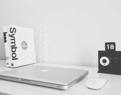 Laptop and books on a white desk