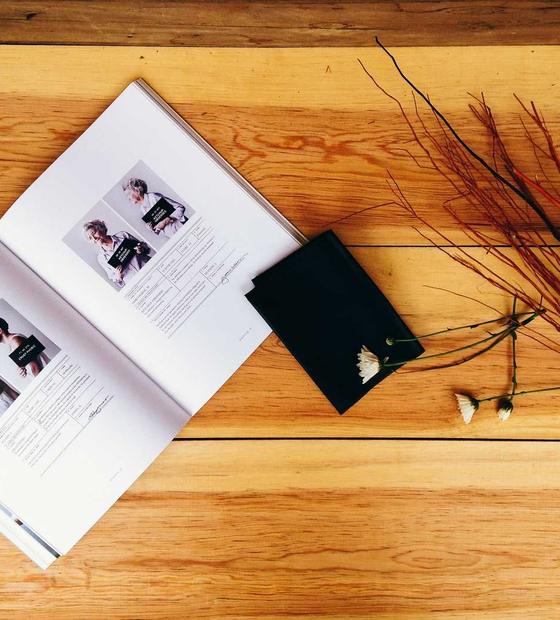 Open book and notebook on a wooden desk