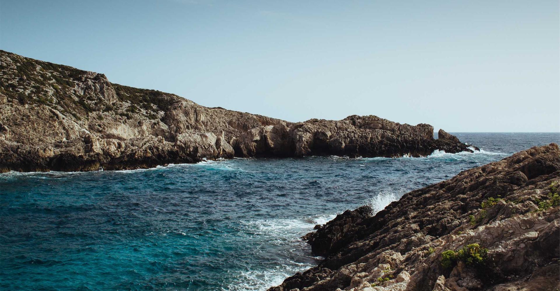 Rocky coastline above a blue sea
